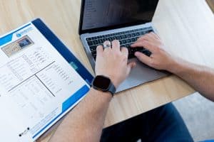 Self storage expert reviewing a feasibility report on a computer for a self storage project